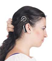Woman showing cochlear implant above her ear